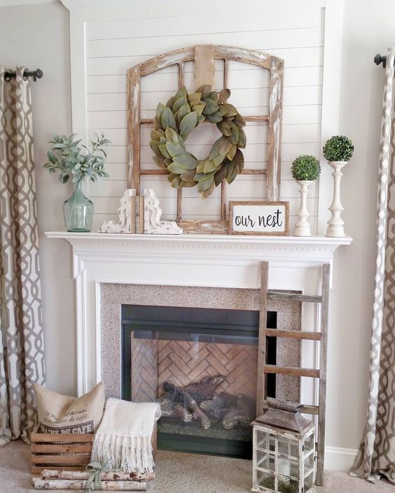 If you’re searching for a more rustic farmhouse look, with some chipped white decor pieces and a hint of fresh green to liven it up, then this rustic farmhouse fireplace is just what you need!