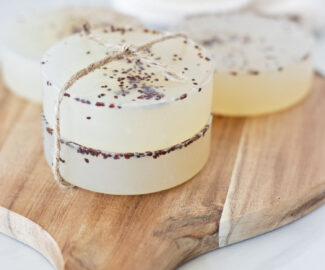 The fun pop of color from cranberry seeds dancing inside these clear soap bars are a great way to celebrate winter’s favorite fruit with an easy one bowl cranberry clear soap recipe!